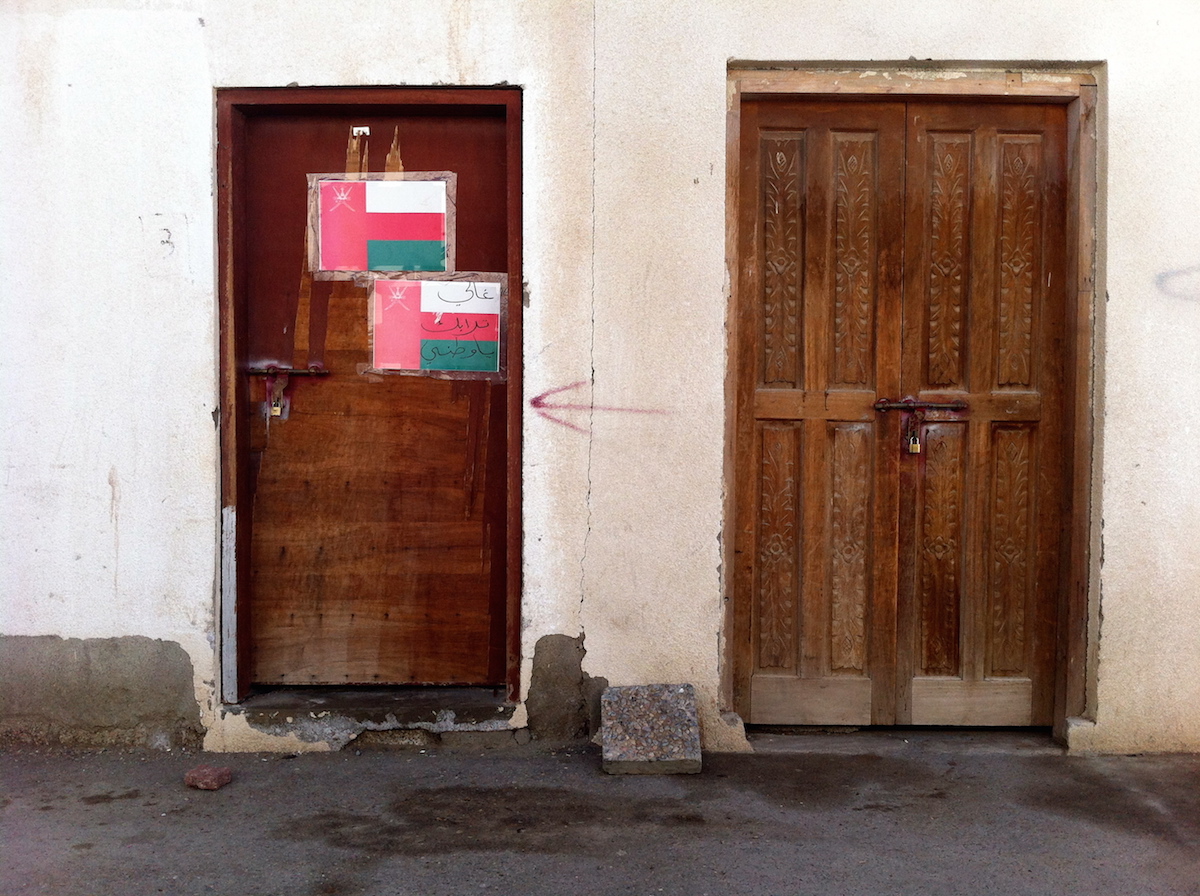 "Precious nation," written on a door in Muscat.